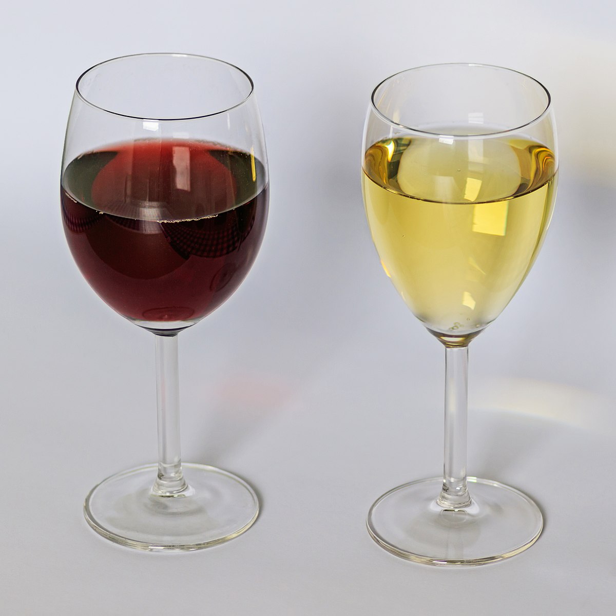 A glass of white wine and a glass of red wine