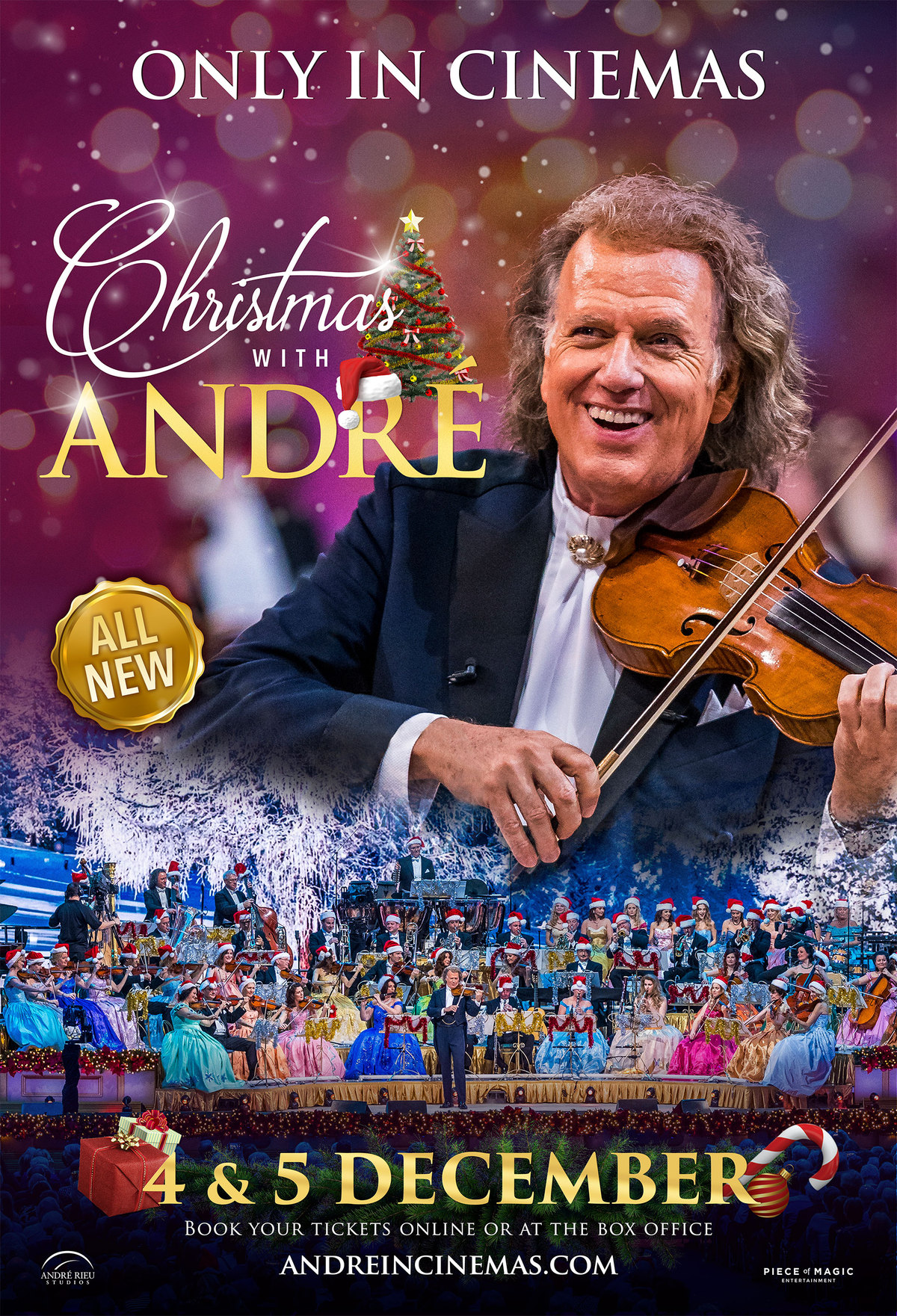 Andre Rieu playing the violin with his orchestra below him.
