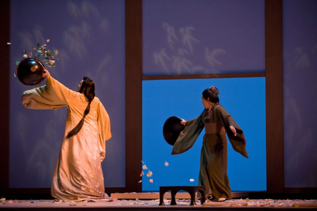 2 ladies throwing petals on stage.