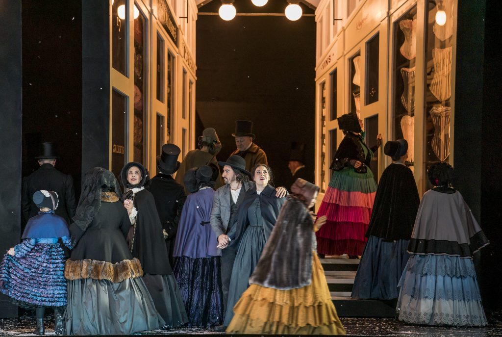 A group of people in period clothing on stage