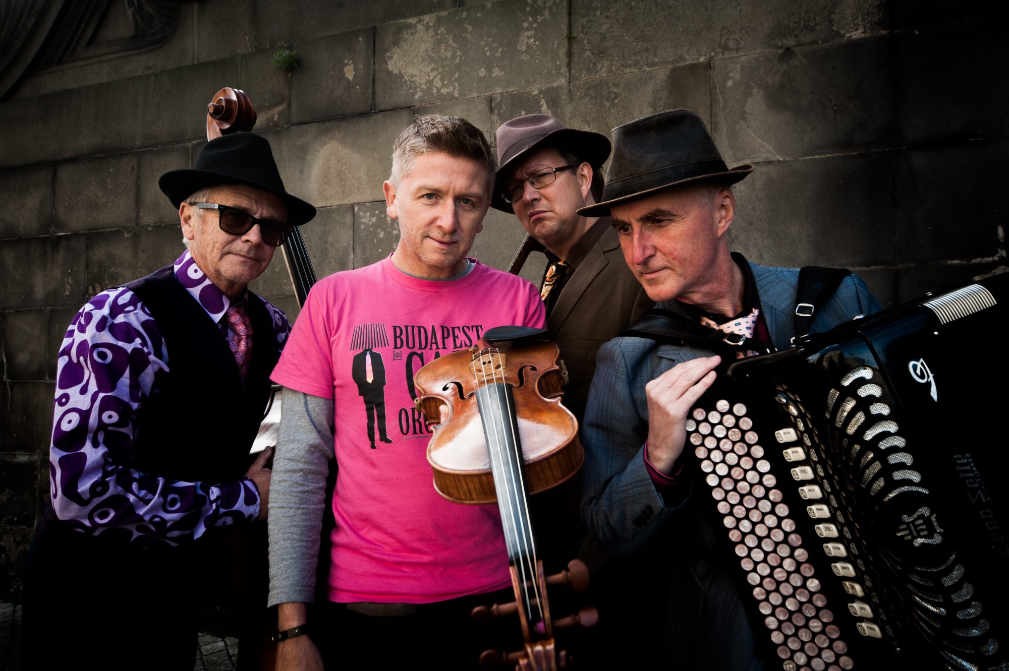 Budapest Cafe Orchestra holding various instruments