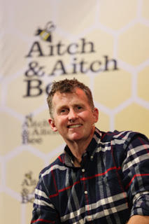 Photo of Nigel Owens in plaid shirt