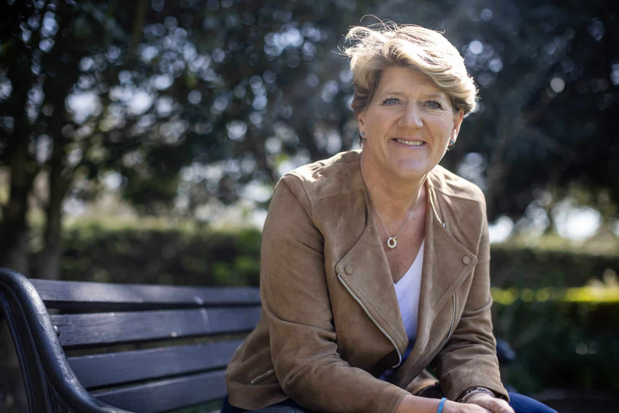 Clare Balding sitting on a park bench